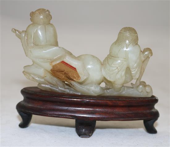 A Chinese pale celadon jade group of the immortals Li Tieguai and He Xiangu, 18th/19th century, 8cm, wood stand